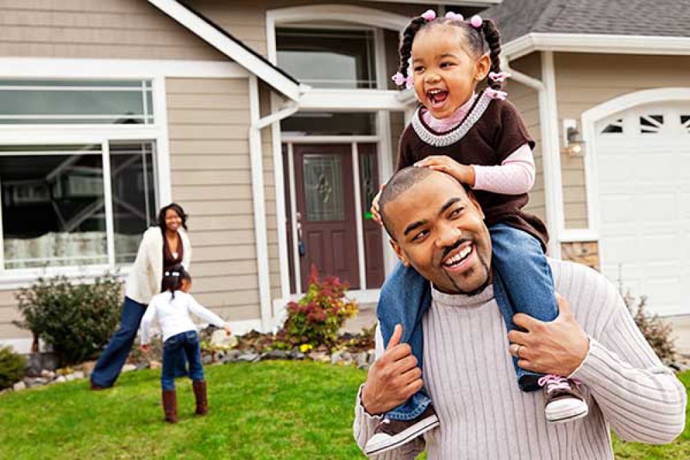 family playing outside in front lawn